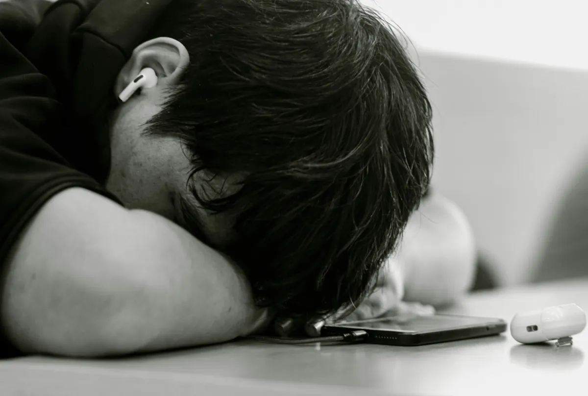 Person looking at their phone with a slow loading website